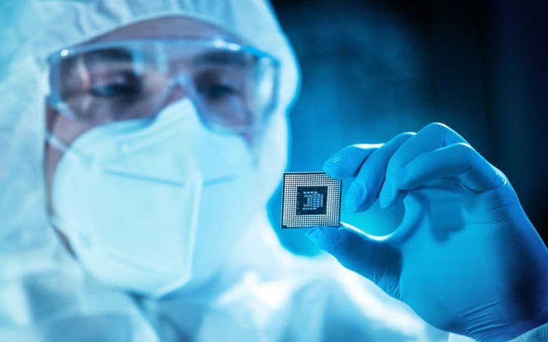 worker holding computer chip