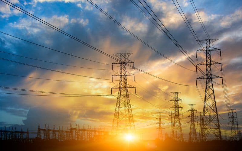 transmission power lines with sun set